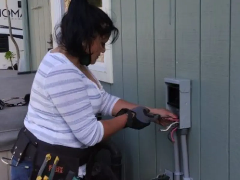 Licensed electrician wiring an exterior subpanel in Rialto